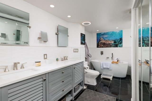1310 Gulf Blvd Unit 6C, Clearwater Beach, FL 33767 - bathroom with tile walls, double vanity, a soaking tub, toilet, and tasteful backsplash