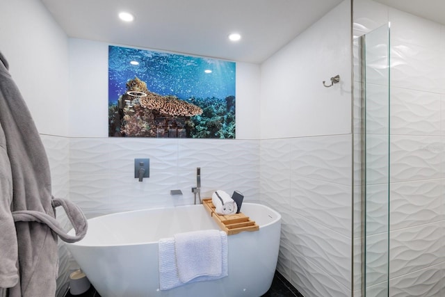 1310 Gulf Blvd Unit 6C, Clearwater Beach, FL 33767 - bathroom with tile walls, recessed lighting, and a soaking tub