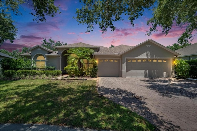 16367 Ashington Park Dr, Tampa, FL 33647 - ranch-style home with a garage, stucco siding, a front yard, and decorative driveway