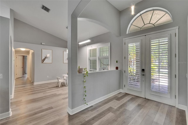 16367 Ashington Park Dr, Tampa, FL 33647 - entryway with french doors, arched walkways, lofted ceiling, wood finished floors, and baseboards