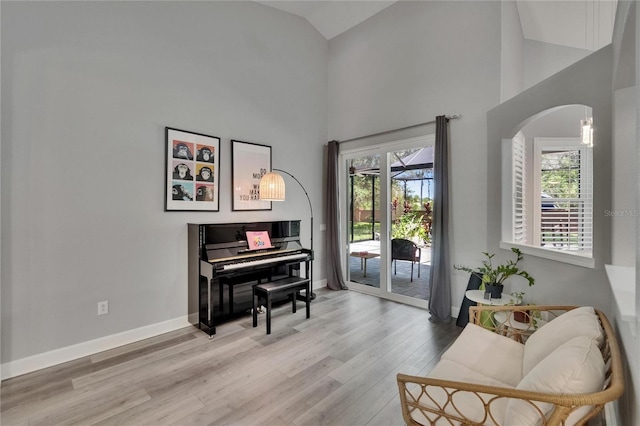 16367 Ashington Park Dr, Tampa, FL 33647 - sitting room with arched walkways, wood finished floors, healthy amount of natural light, baseboards, and high vaulted ceiling