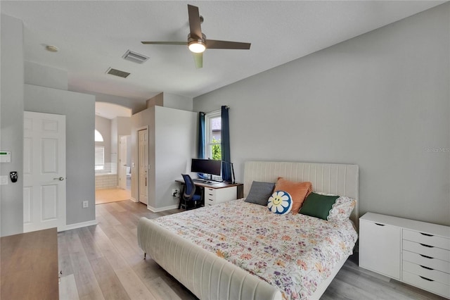 16367 Ashington Park Dr, Tampa, FL 33647 - bedroom featuring light wood finished floors, baseboards, arched walkways, and ensuite bath