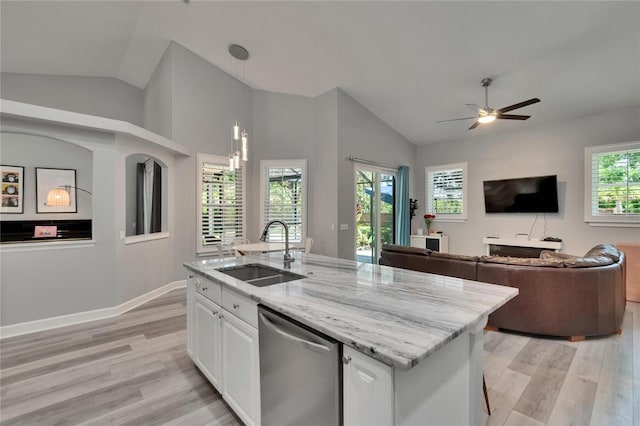 16367 Ashington Park Dr, Tampa, FL 33647 - kitchen with a sink, dishwasher, vaulted ceiling, light wood finished floors, and light stone countertops