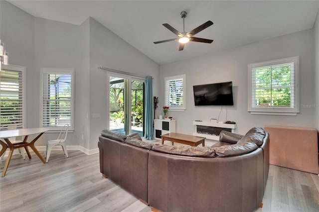 16367 Ashington Park Dr, Tampa, FL 33647 - living area featuring light wood-type flooring, a ceiling fan, high vaulted ceiling, and baseboards