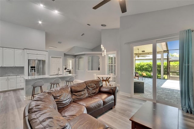 16367 Ashington Park Dr, Tampa, FL 33647 - living room featuring a ceiling fan, light wood-style floors, high vaulted ceiling, baseboards, and recessed lighting