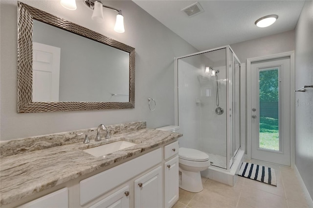 16367 Ashington Park Dr, Tampa, FL 33647 - bathroom featuring toilet, a shower stall, vanity, and tile patterned floors