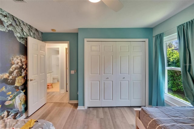 16367 Ashington Park Dr, Tampa, FL 33647 - bedroom featuring light wood-type flooring, a closet, baseboards, and an accent wall