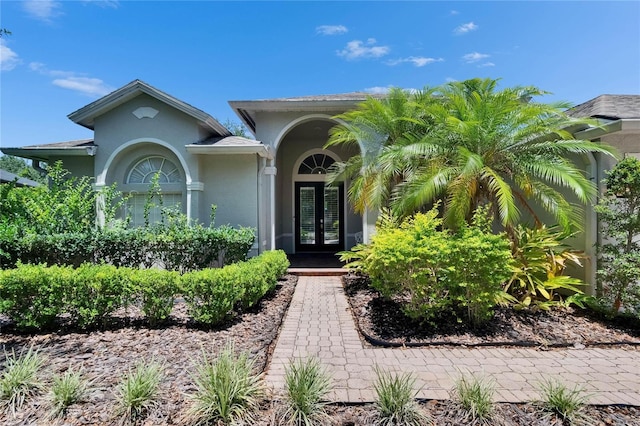16367 Ashington Park Dr, Tampa, FL 33647 - property entrance featuring french doors and stucco siding