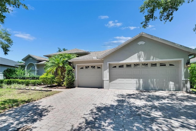 16367 Ashington Park Dr, Tampa, FL 33647 - ranch-style home with stucco siding, decorative driveway, and a garage