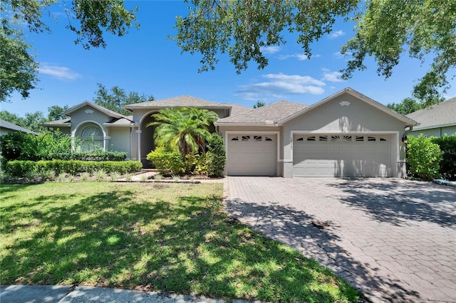 16367 Ashington Park Dr, Tampa, FL 33647 - ranch-style house featuring a garage, stucco siding, a front yard, and decorative driveway