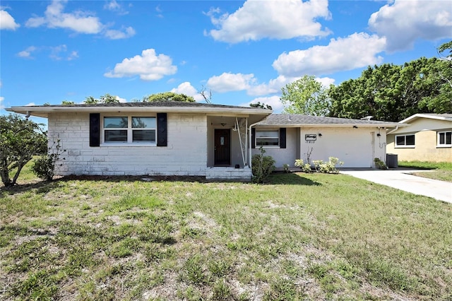 7810 Pineapple Ln, Port Richey, FL 34668 - ranch-style home with a front lawn, concrete driveway, and an attached garage