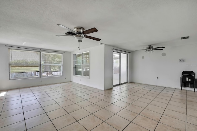 7810 Pineapple Ln, Port Richey, FL 34668 - spare room featuring ceiling fan, light tile patterned floors, and a textured ceiling