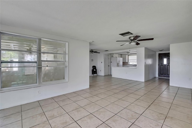 7810 Pineapple Ln, Port Richey, FL 34668 - unfurnished living room featuring a ceiling fan and light tile patterned flooring