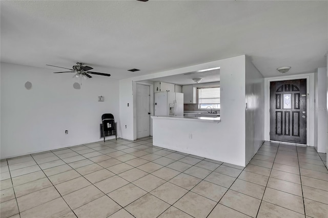 7810 Pineapple Ln, Port Richey, FL 34668 - unfurnished living room featuring light tile patterned floors, a sink, and a ceiling fan
