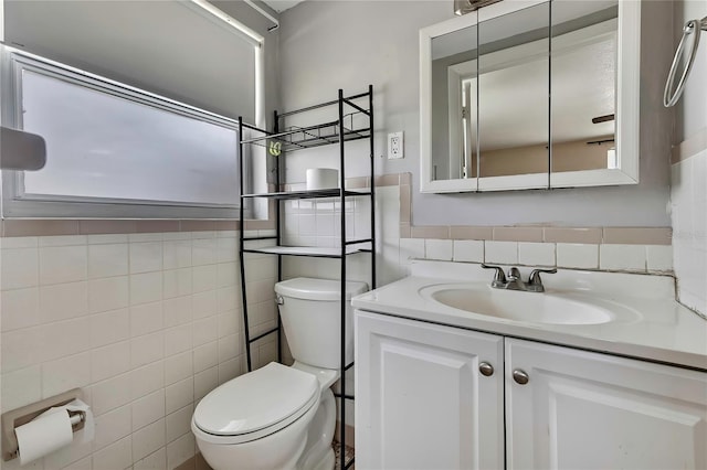 7810 Pineapple Ln, Port Richey, FL 34668 - half bathroom featuring tile walls, toilet, vanity, and wainscoting
