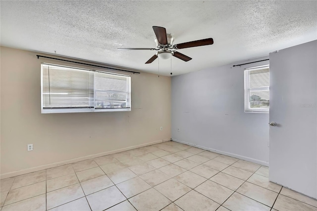 7810 Pineapple Ln, Port Richey, FL 34668 - empty room with a textured ceiling, a ceiling fan, baseboards, and light tile patterned flooring