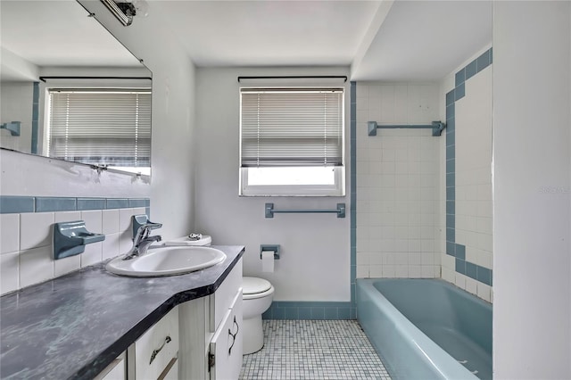 7810 Pineapple Ln, Port Richey, FL 34668 - bathroom with vanity, tile patterned floors, toilet, and  shower combination