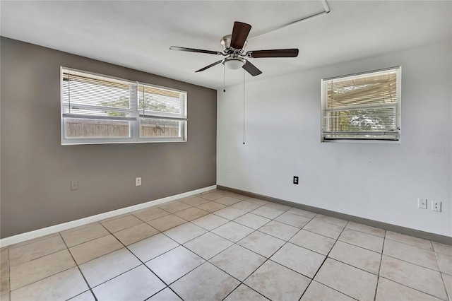 7810 Pineapple Ln, Port Richey, FL 34668 - empty room with light tile patterned floors, a ceiling fan, and baseboards