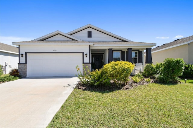 12517 Nantahala Run, Parrish, FL 34219 - view of front of house with a front lawn, a garage, and concrete driveway