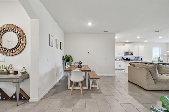 12517 Nantahala Run, Parrish, FL 34219 - living area featuring recessed lighting, arched walkways, and light tile patterned floors