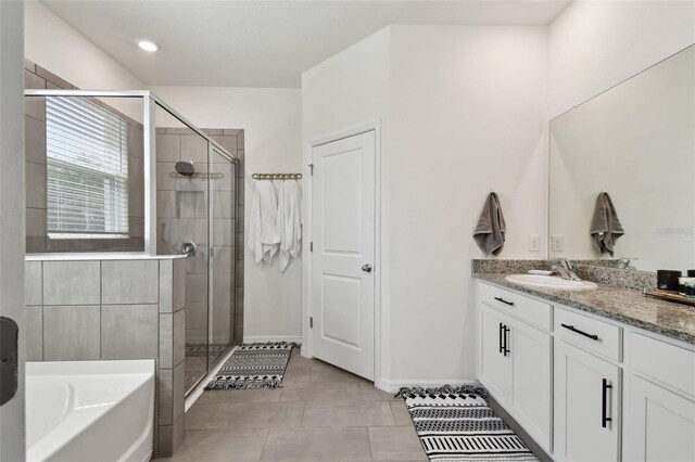 12517 Nantahala Run, Parrish, FL 34219 - bathroom featuring vanity, a bath, a stall shower, and baseboards