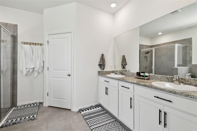 12517 Nantahala Run, Parrish, FL 34219 - bathroom featuring double vanity, a stall shower, baseboards, tile patterned flooring, and recessed lighting