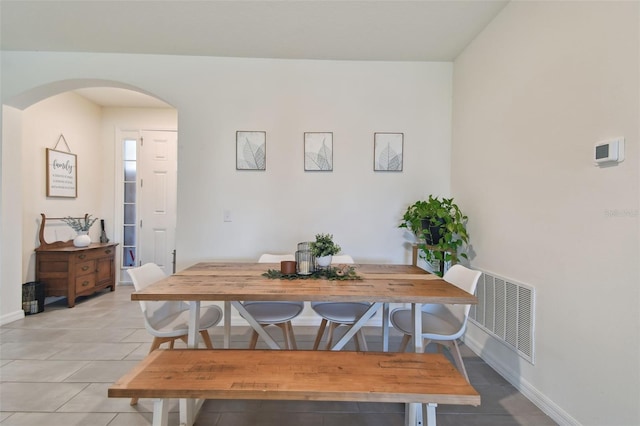 12517 Nantahala Run, Parrish, FL 34219 - dining space featuring arched walkways, baseboards, and light tile patterned flooring