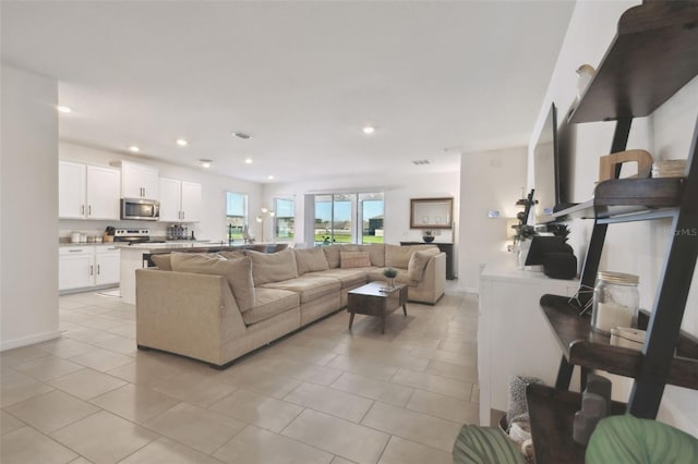 12517 Nantahala Run, Parrish, FL 34219 - living room with light tile patterned floors, recessed lighting, and baseboards