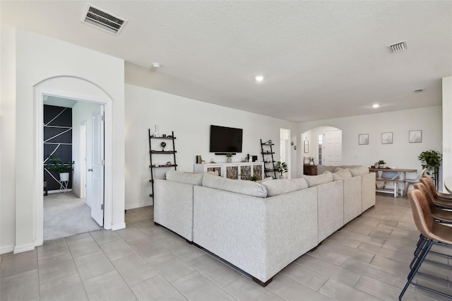 12517 Nantahala Run, Parrish, FL 34219 - living room featuring arched walkways and recessed lighting