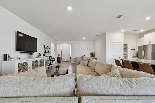 12517 Nantahala Run, Parrish, FL 34219 - living room featuring arched walkways and recessed lighting