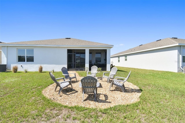12517 Nantahala Run, Parrish, FL 34219 - rear view of house with a sunroom, a lawn, central AC, and stucco siding