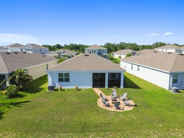 12517 Nantahala Run, Parrish, FL 34219 - back of property with a residential view, a fire pit, a lawn, and a sunroom