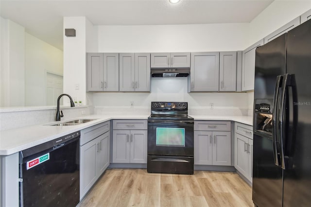 105 1st Ave SE, Lutz, FL 33549 - kitchen featuring black appliances, gray cabinetry, and a sink