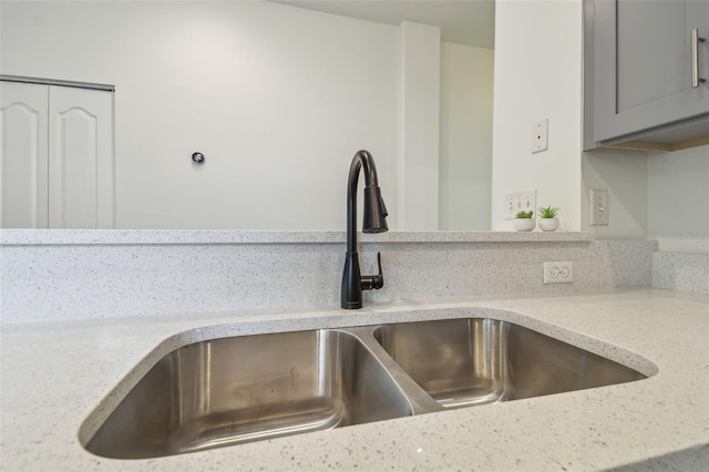 105 1st Ave SE, Lutz, FL 33549 - kitchen view of a sink, gray cabinetry, and light stone countertops