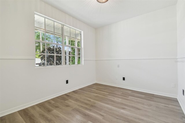 105 1st Ave SE, Lutz, FL 33549 - unfurnished room featuring wood finished floors and baseboards
