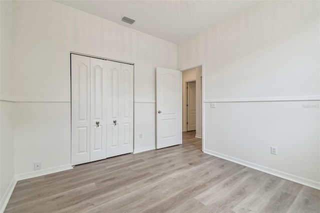 105 1st Ave SE, Lutz, FL 33549 - unfurnished bedroom featuring light wood-style flooring, a closet, and baseboards