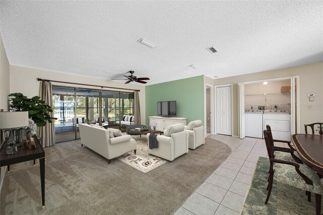 70 Cypress Pl, Oldsmar, FL 34677 - living area featuring ceiling fan, light tile patterned floors, washing machine and clothes dryer, and a textured ceiling