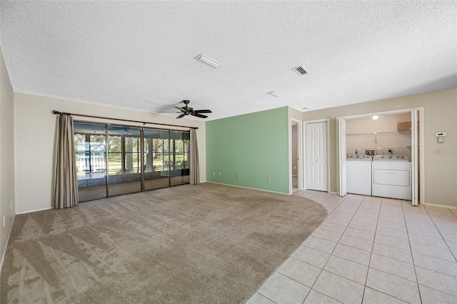 70 Cypress Pl, Oldsmar, FL 34677 - unfurnished living room featuring independent washer and dryer, ceiling fan, light tile patterned floors, a textured ceiling, and baseboards