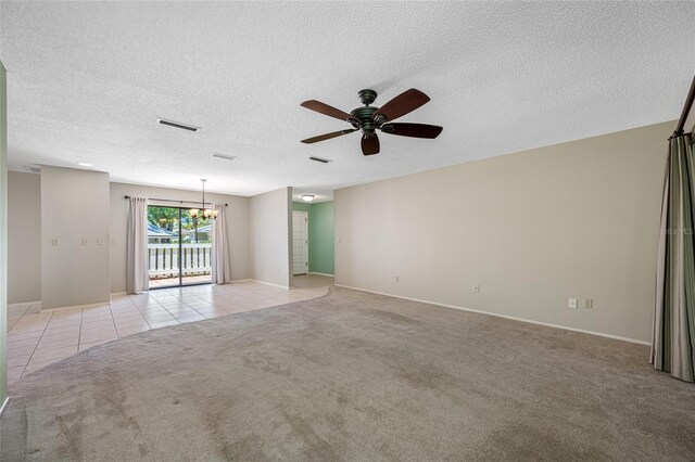 70 Cypress Pl, Oldsmar, FL 34677 - spare room with a chandelier, light carpet, ceiling fan, light tile patterned floors, and a textured ceiling