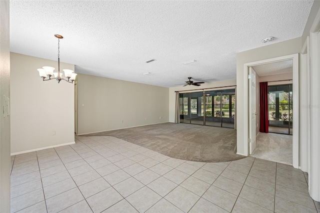 70 Cypress Pl, Oldsmar, FL 34677 - spare room featuring a chandelier, healthy amount of natural light, light colored carpet, a ceiling fan, and a textured ceiling