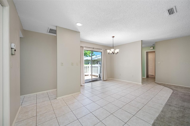 70 Cypress Pl, Oldsmar, FL 34677 - spare room with a chandelier, a textured ceiling, light tile patterned floors, and baseboards