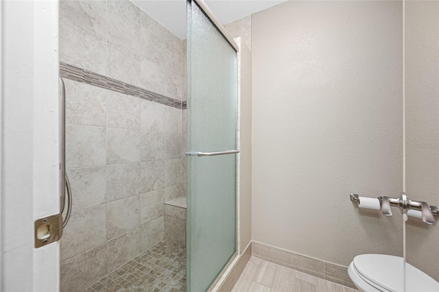 70 Cypress Pl, Oldsmar, FL 34677 - bathroom featuring a shower stall, toilet, and baseboards