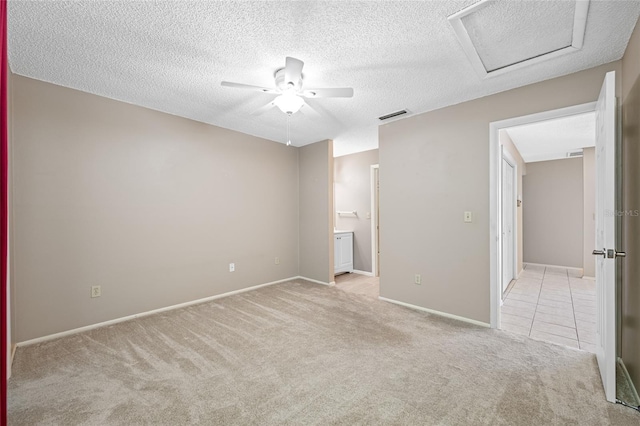 70 Cypress Pl, Oldsmar, FL 34677 - unfurnished bedroom featuring carpet floors, attic access, a textured ceiling, baseboards, and connected bathroom