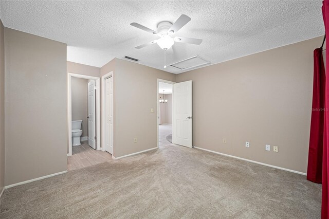 70 Cypress Pl, Oldsmar, FL 34677 - unfurnished bedroom featuring carpet flooring, a textured ceiling, attic access, baseboards, and ensuite bath