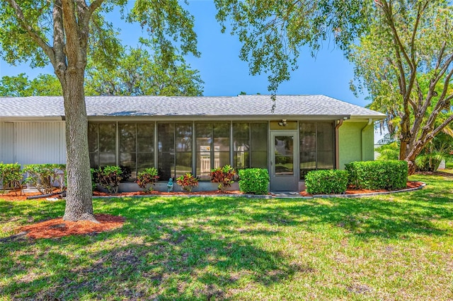 70 Cypress Pl, Oldsmar, FL 34677 - back of house featuring a sunroom, a yard, and a shingled roof