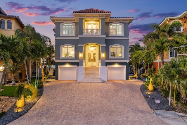 16365 Redington Dr, Redington Beach, FL 33708 - view of front of property with a balcony, stucco siding, decorative driveway, an attached garage, and a tile roof