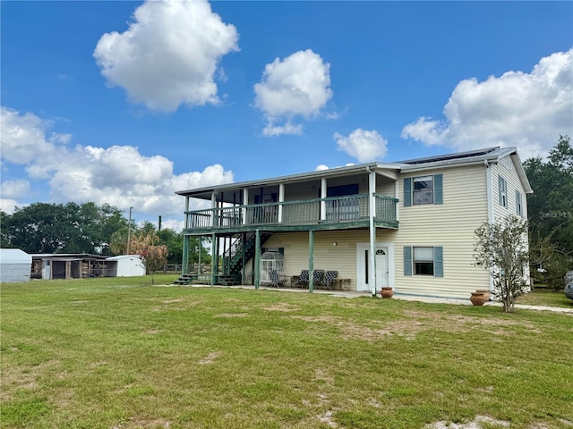 439 Corbett Rd, Lithia, FL 33547 - back of house featuring stairs, a yard, a wooden deck, and a patio