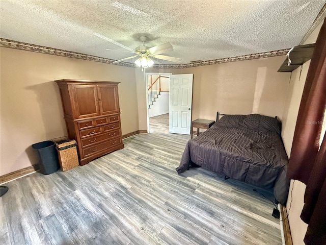 439 Corbett Rd, Lithia, FL 33547 - bedroom featuring light wood-type flooring, a textured ceiling, ceiling fan, and baseboards