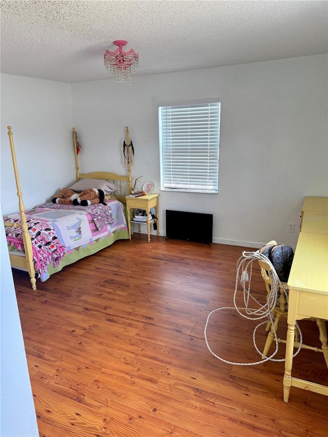 439 Corbett Rd, Lithia, FL 33547 - bedroom with wood finished floors and a textured ceiling