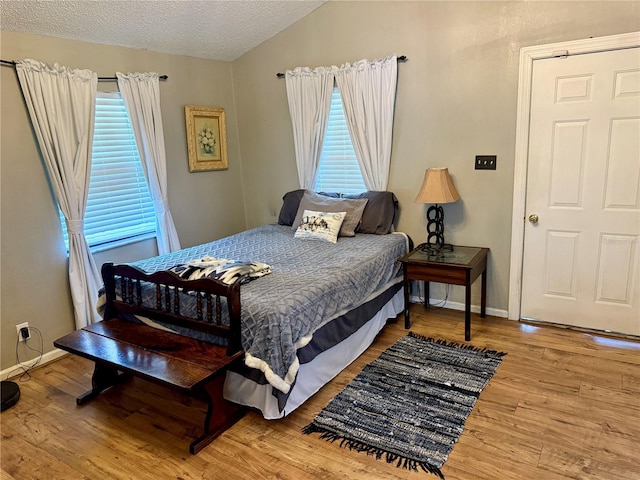 439 Corbett Rd, Lithia, FL 33547 - bedroom with wood finished floors, multiple windows, baseboards, and a textured ceiling